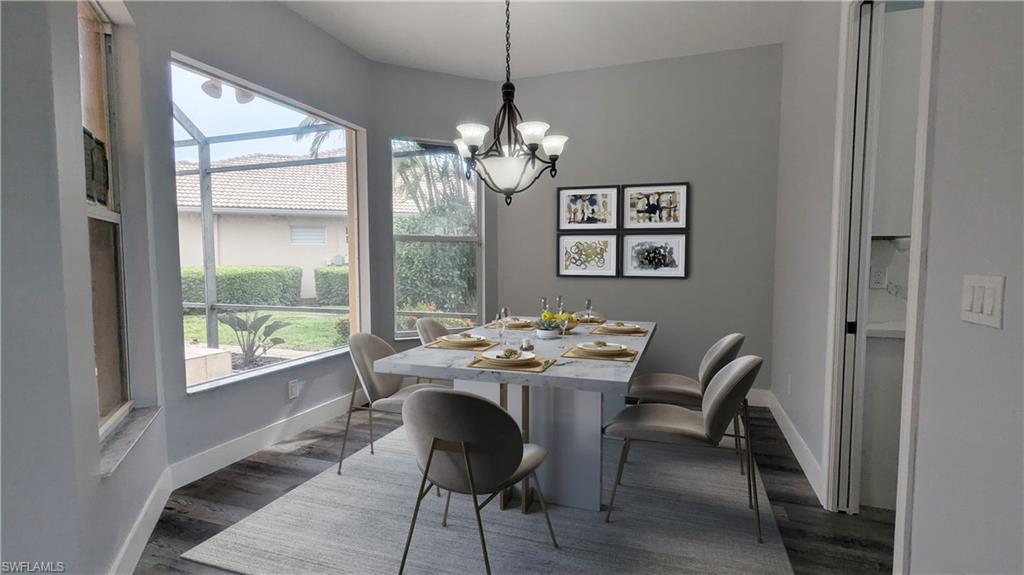 Dining room featuring dark hardwood / wood-style floors and an inviting chandelier