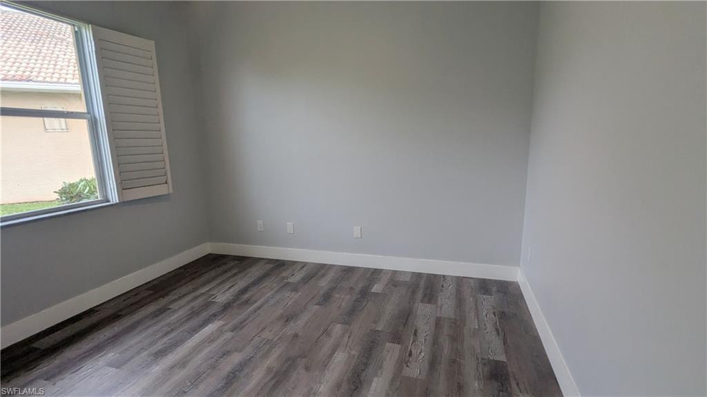Empty room featuring wood-type flooring
