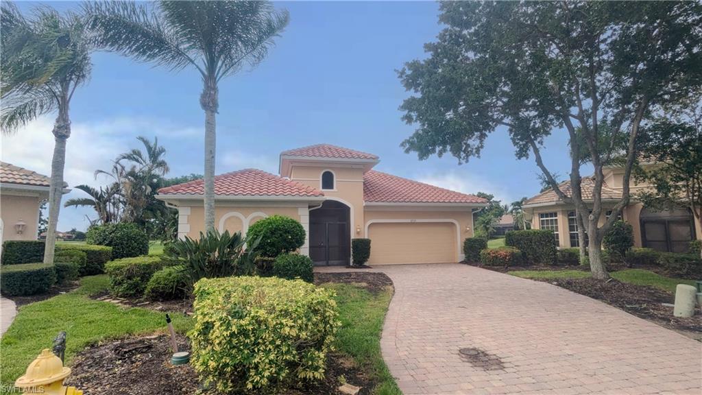 Mediterranean / spanish-style house featuring a garage