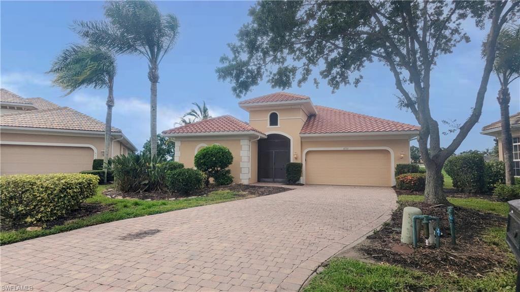 Mediterranean / spanish-style house with a garage