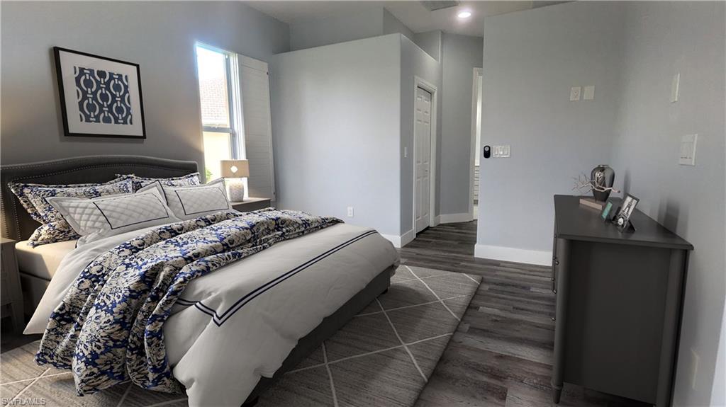 Bedroom with dark hardwood / wood-style flooring