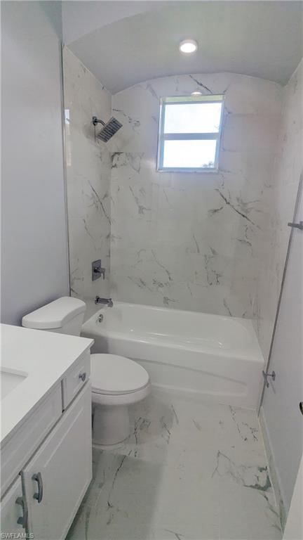 Full bathroom with vanity, toilet, and tiled shower / bath