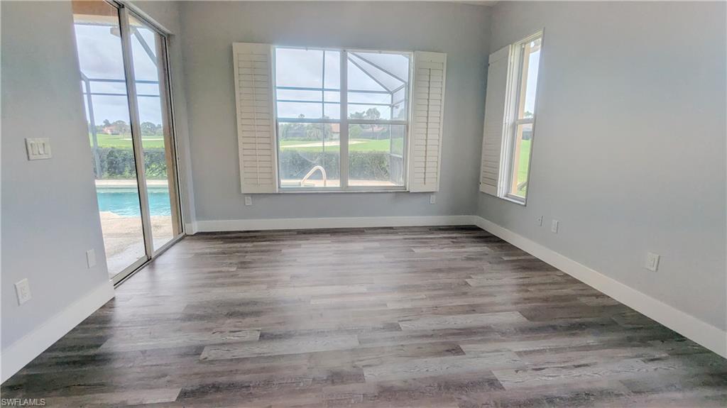 Spare room featuring wood-type flooring