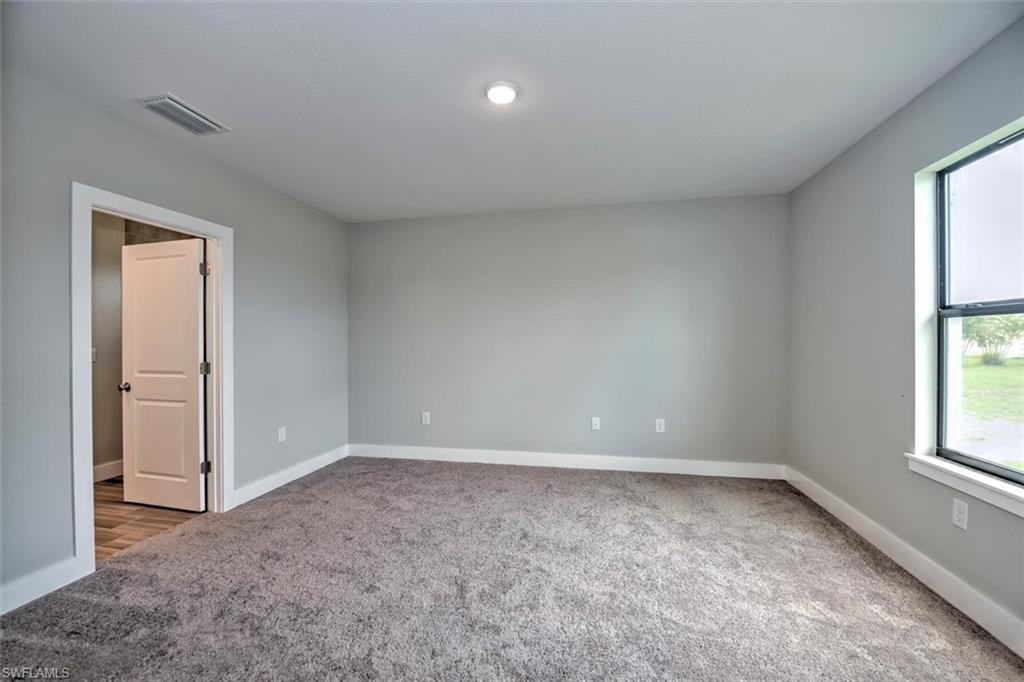 Unfurnished room with carpet flooring
