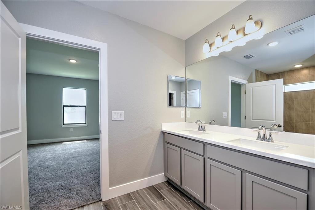 Bathroom with vanity and hardwood / wood-style floors