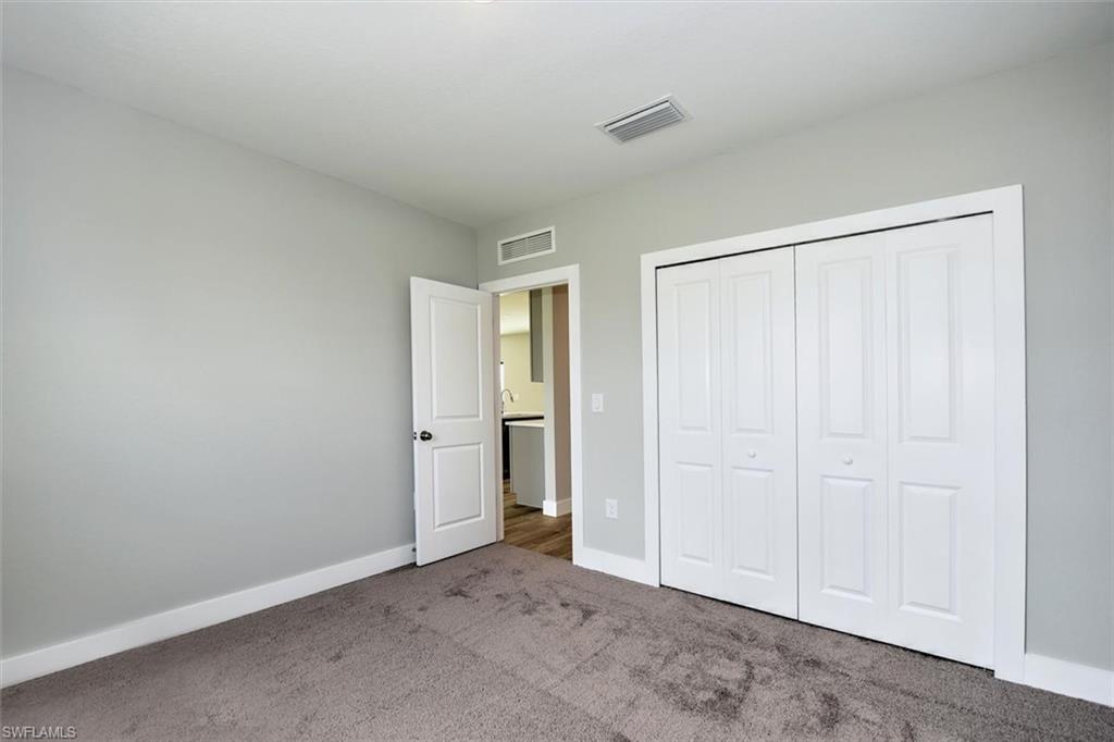 Unfurnished bedroom with a closet and carpet