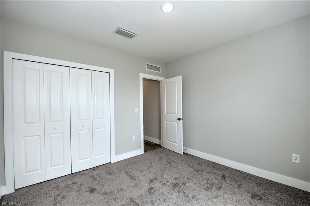 Unfurnished bedroom with carpet flooring and a closet