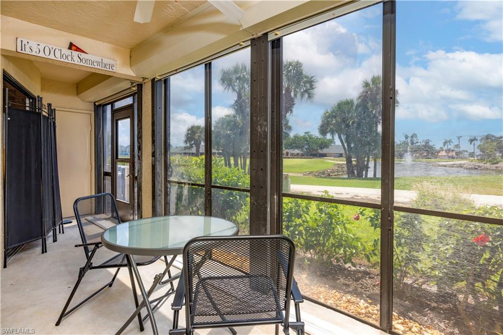 Sunroom featuring a water view