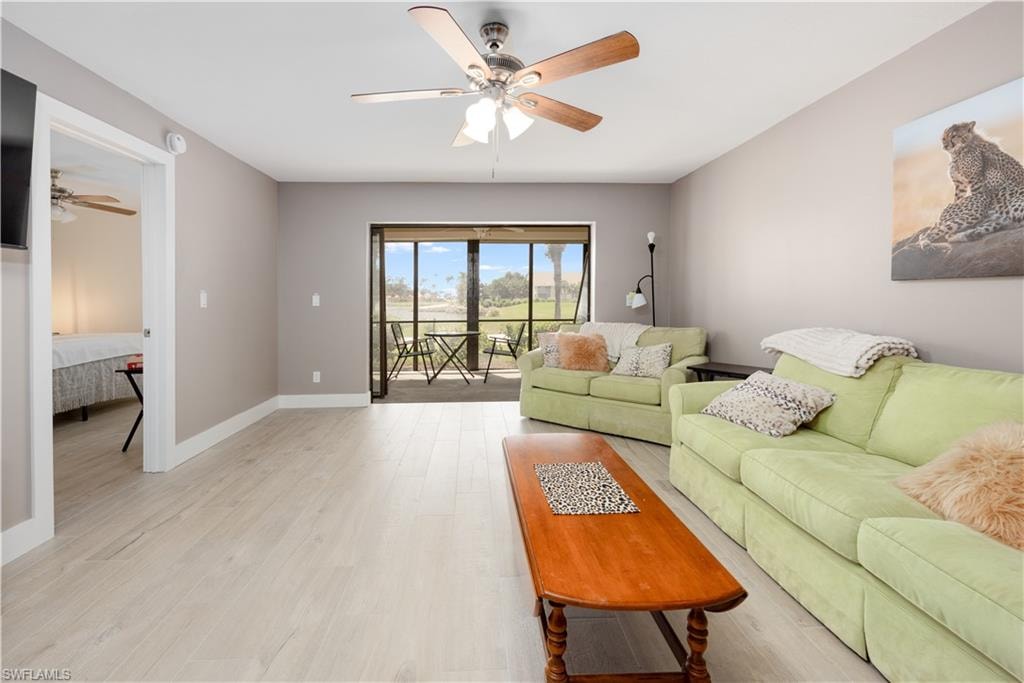 Living room with light hardwood / wood-style flooring and ceiling fan