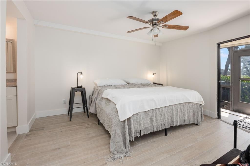 Bedroom featuring light hardwood / wood-style flooring, ceiling fan, and access to exterior