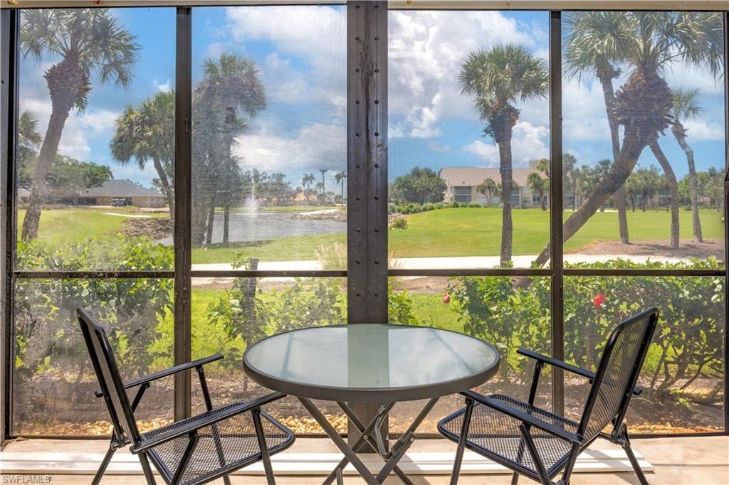 Sunroom / solarium with a wealth of natural light and a water view