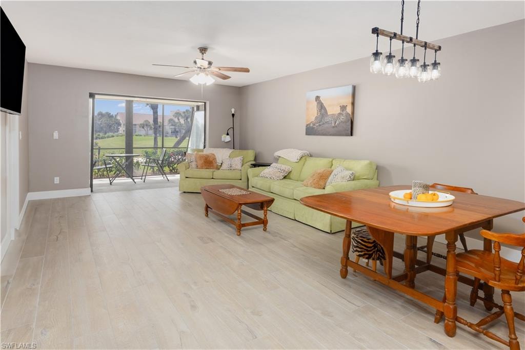 Living room featuring light wood-type flooring and ceiling fan