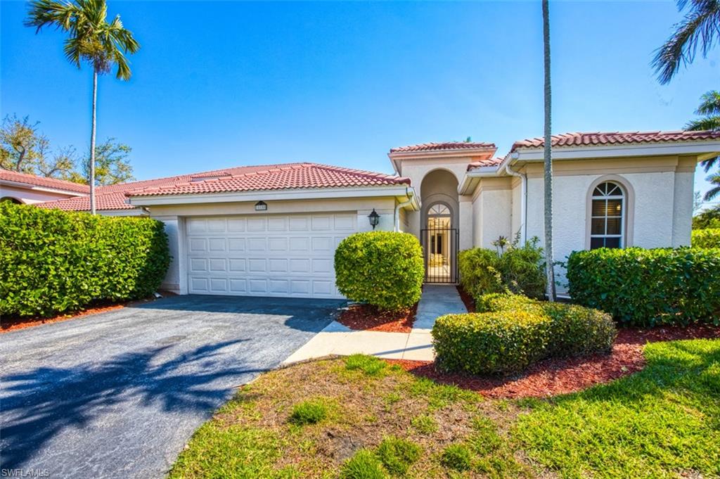 Mediterranean / spanish-style house with a garage