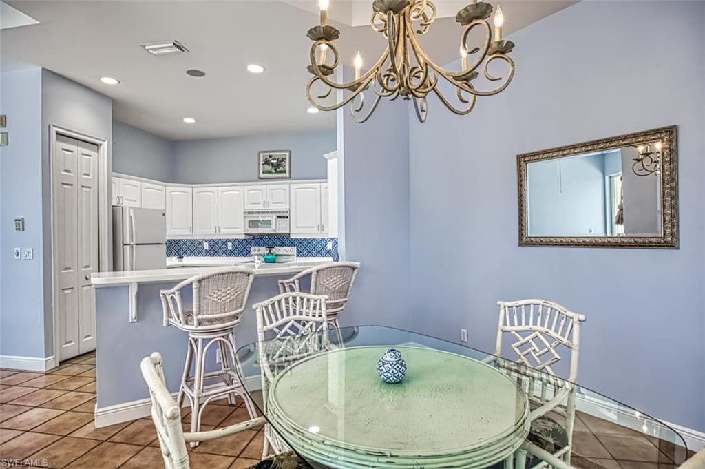 Tiled dining space featuring an inviting chandelier