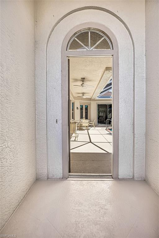 Doorway to property with ceiling fan and french doors