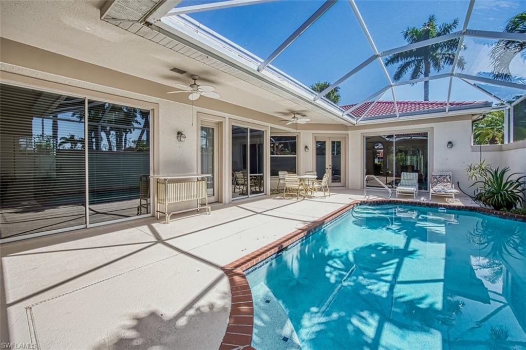 View of swimming pool with a lanai, a patio, and ceiling fan