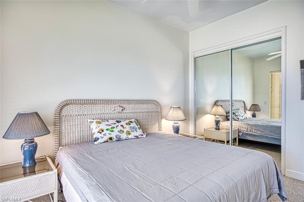 Carpeted bedroom with a closet and ceiling fan