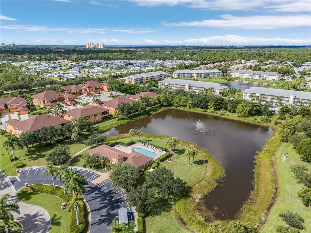 Birds eye view of property with a water view