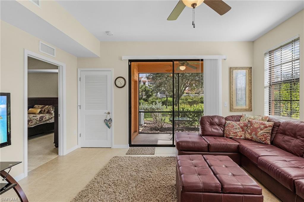 Tiled living room featuring ceiling fan