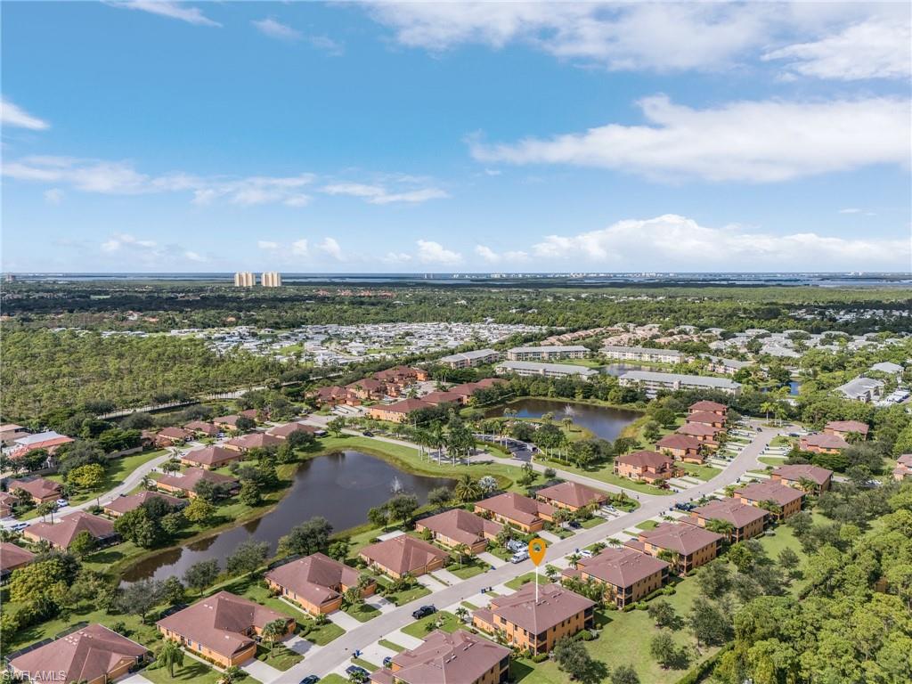 Birds eye view of property with a water view