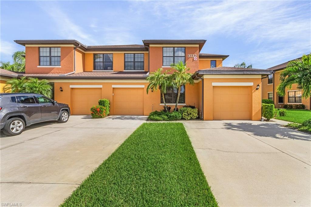View of front of house with a front yard and a garage