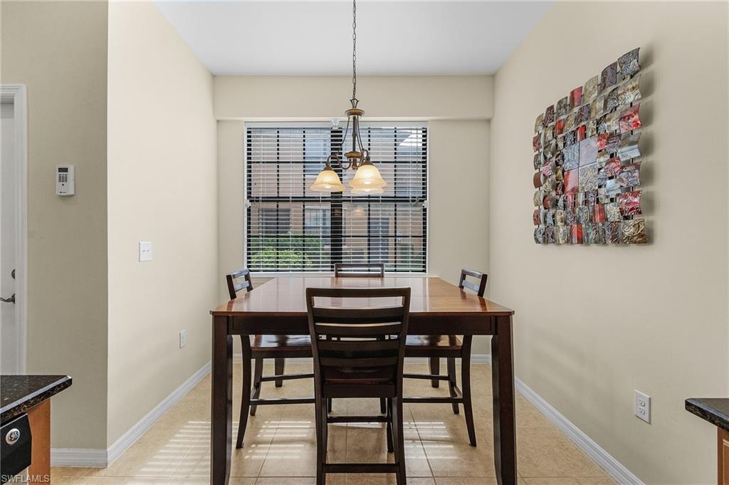 Tiled dining area with a chandelier