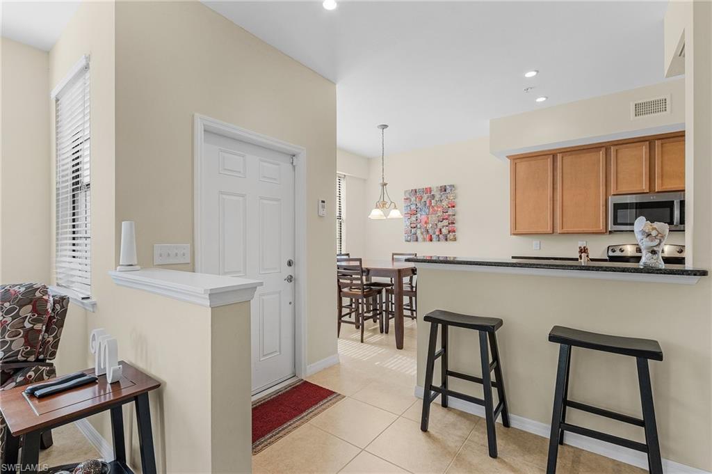 Kitchen featuring a wealth of natural light, stainless steel appliances, and kitchen peninsula