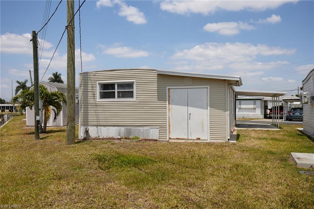 Back of property featuring a yard