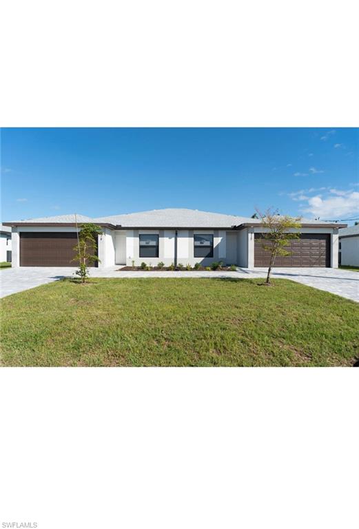 Ranch-style home featuring a garage and a front lawn