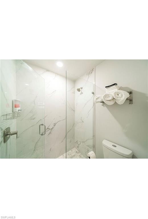 Bathroom with toilet and a shower with door