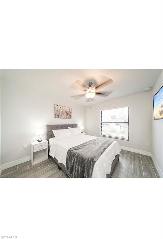 Bedroom featuring ceiling fan and hardwood / wood-style floors