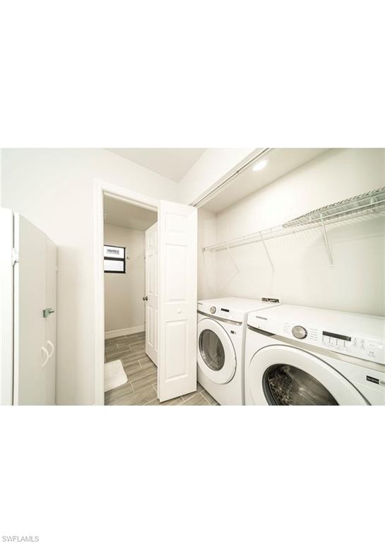 Clothes washing area featuring light hardwood / wood-style flooring and independent washer and dryer