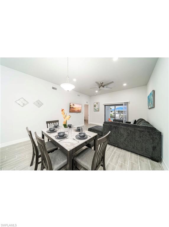 Dining area with light wood-type flooring and ceiling fan