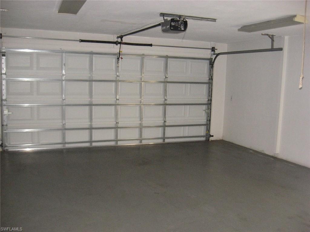 Garage featuring a garage door opener