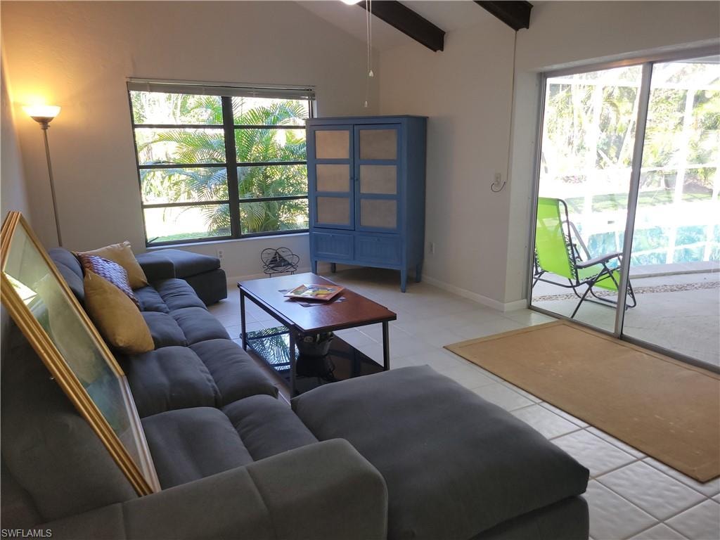 Tiled living room with lofted ceiling