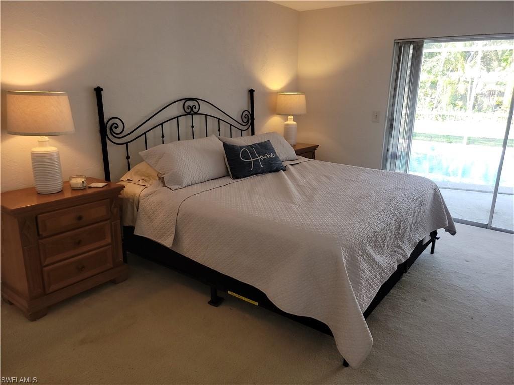 Carpeted bedroom with access to exterior