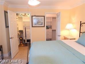 Bedroom with ornamental molding and a closet
