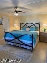 Bedroom with tile patterned flooring, ornamental molding, and ceiling fan