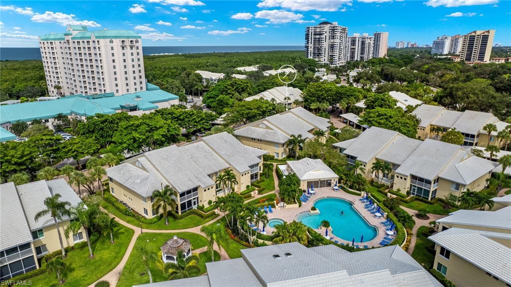 Birds eye view of property with a water view
