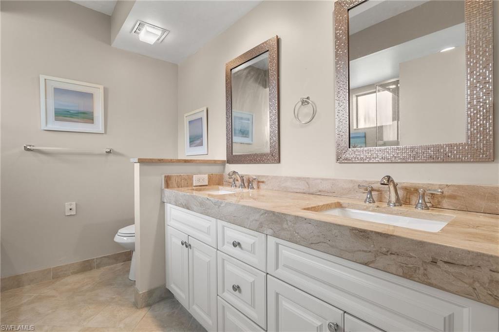 Bathroom with vanity, toilet, and tile patterned floors
