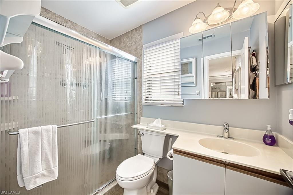 Primary bathroom with an enclosed shower.