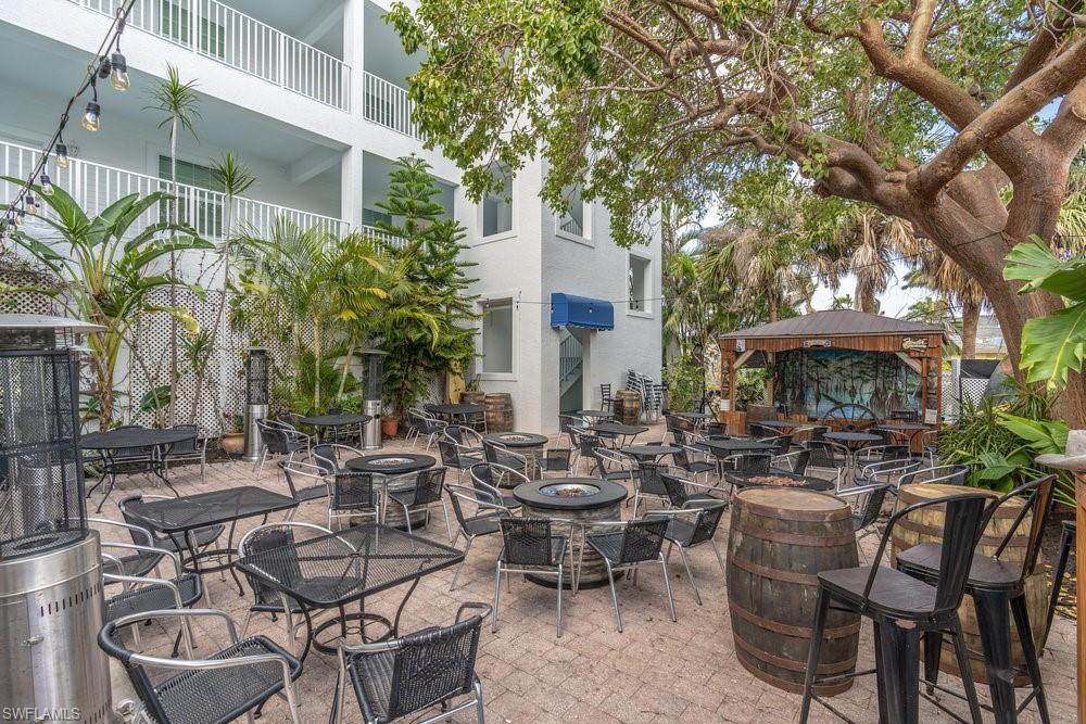 View of patio with a balcony, a gazebo, and an outdoor fire pit