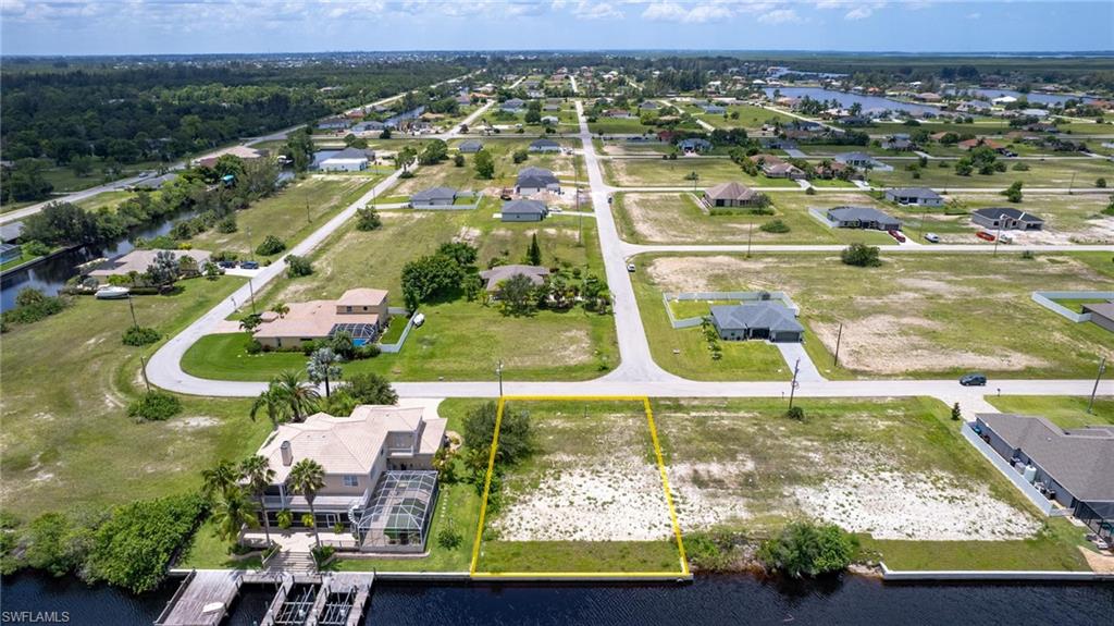 Birds eye view of property with a water view