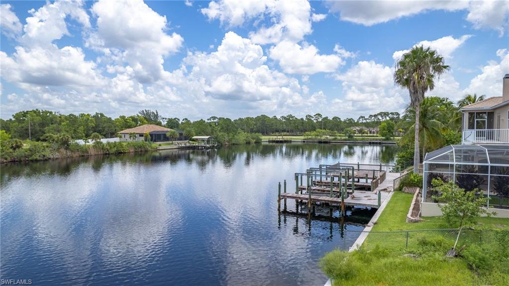 View of dock featuring a lanai and a water view