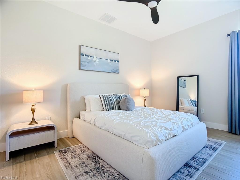 Bedroom featuring wood-type flooring and ceiling fan