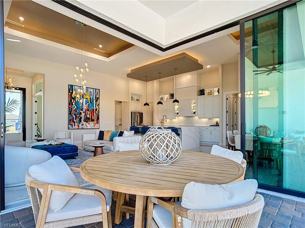 Dining space featuring an inviting chandelier and a tray ceiling