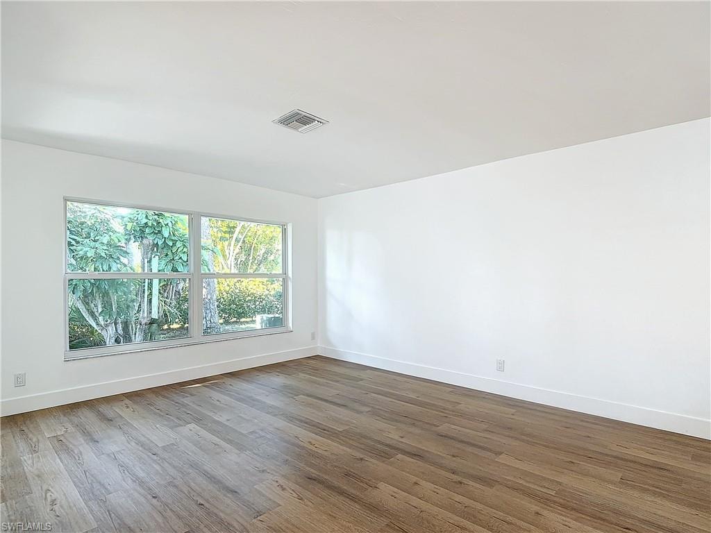 Spare room featuring hardwood / wood-style flooring