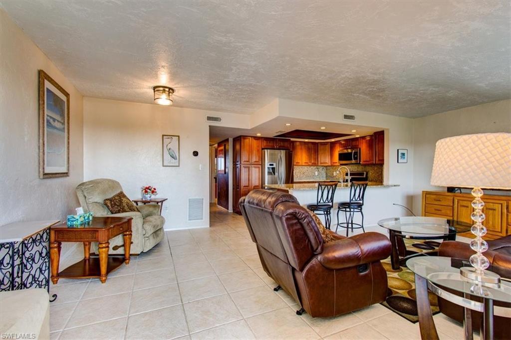 Tiled living room with a textured ceiling and sink