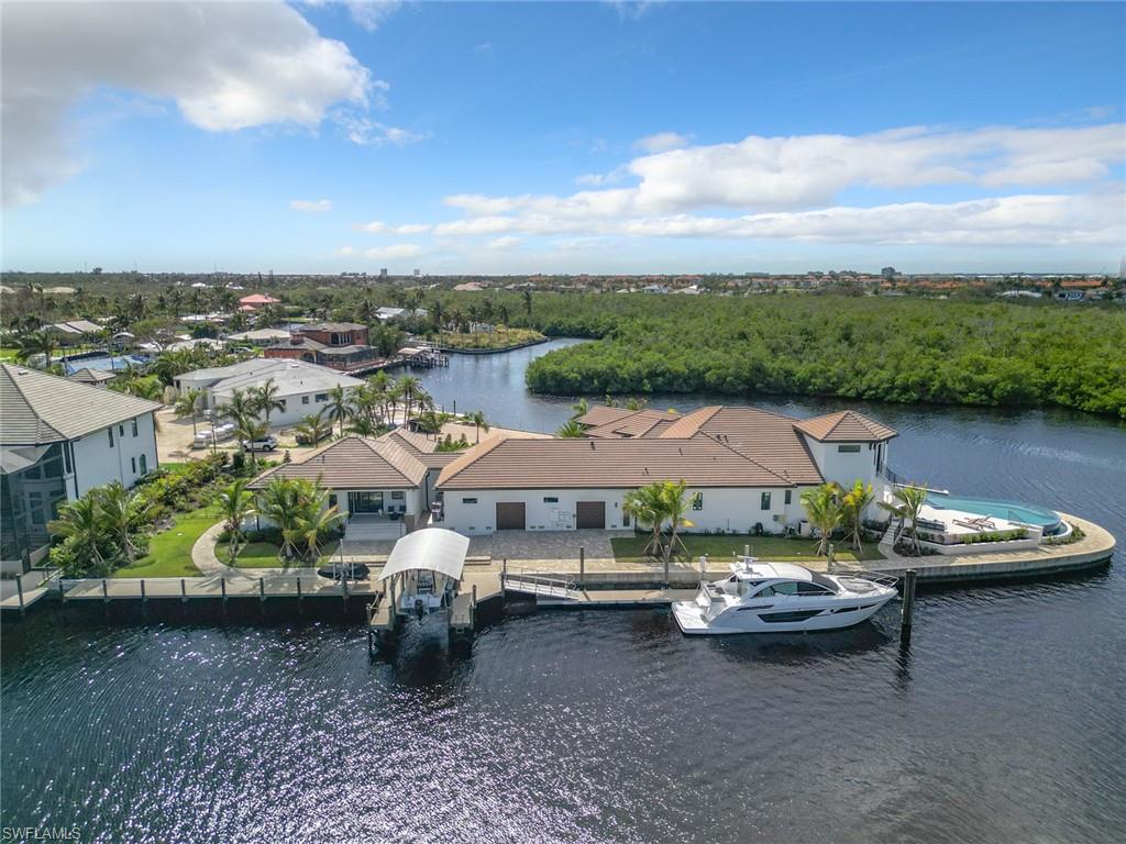 Privacy beyond on this over sized corner lot with 100' floating dock and covered boat lift.
