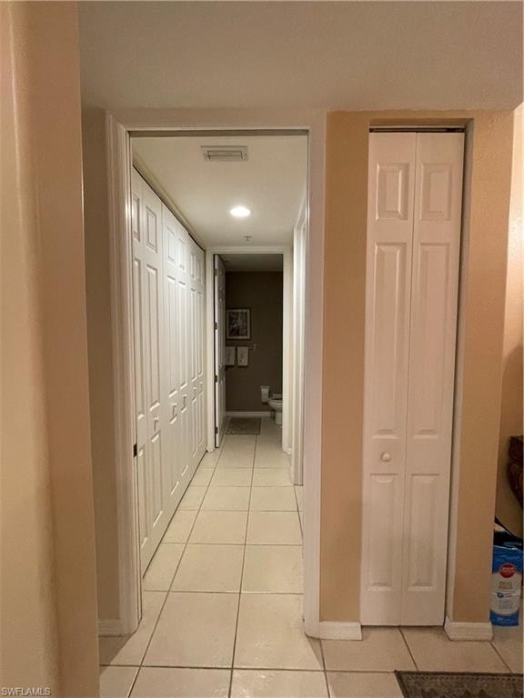 Hallway featuring light tile patterned floors